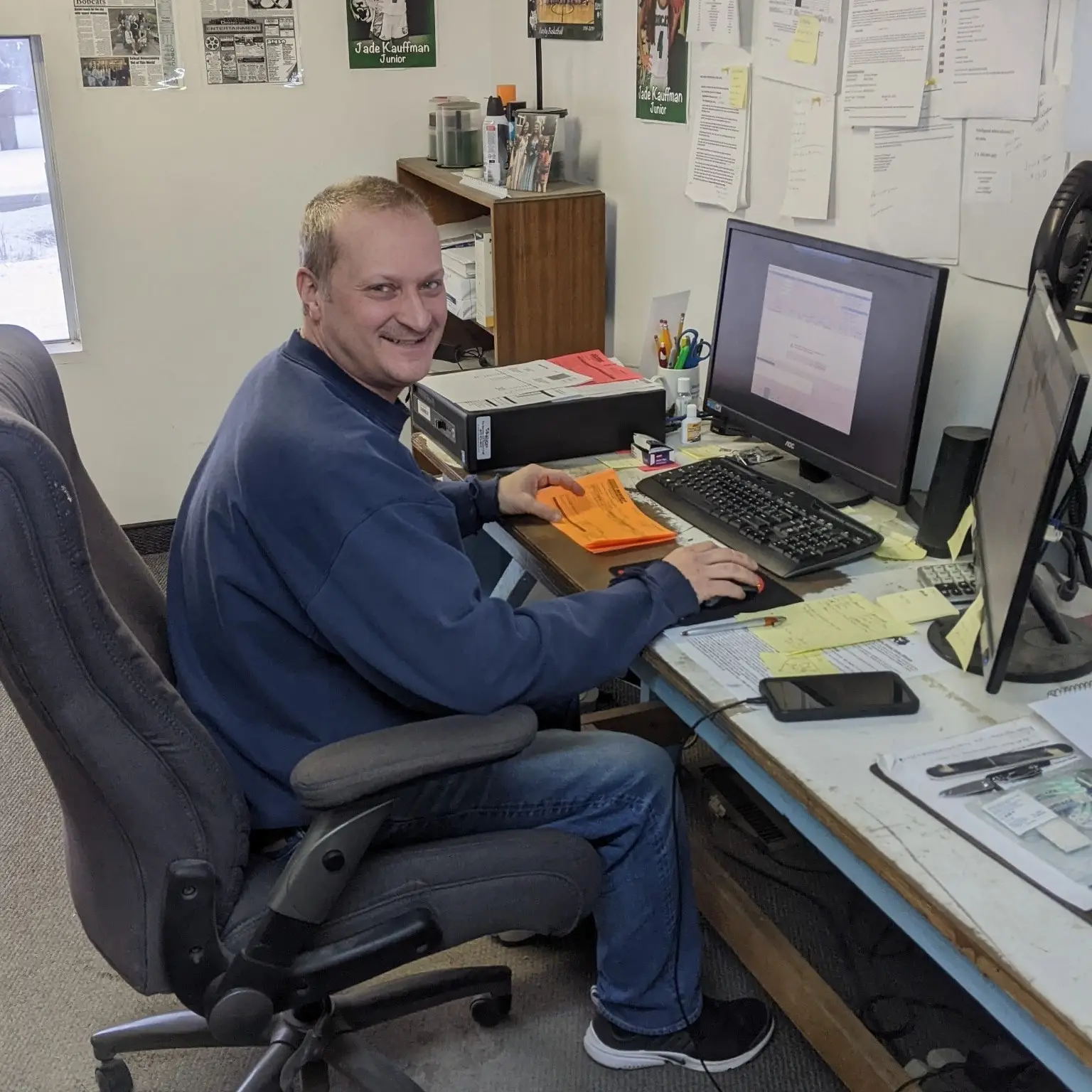 Greg sitting at desk